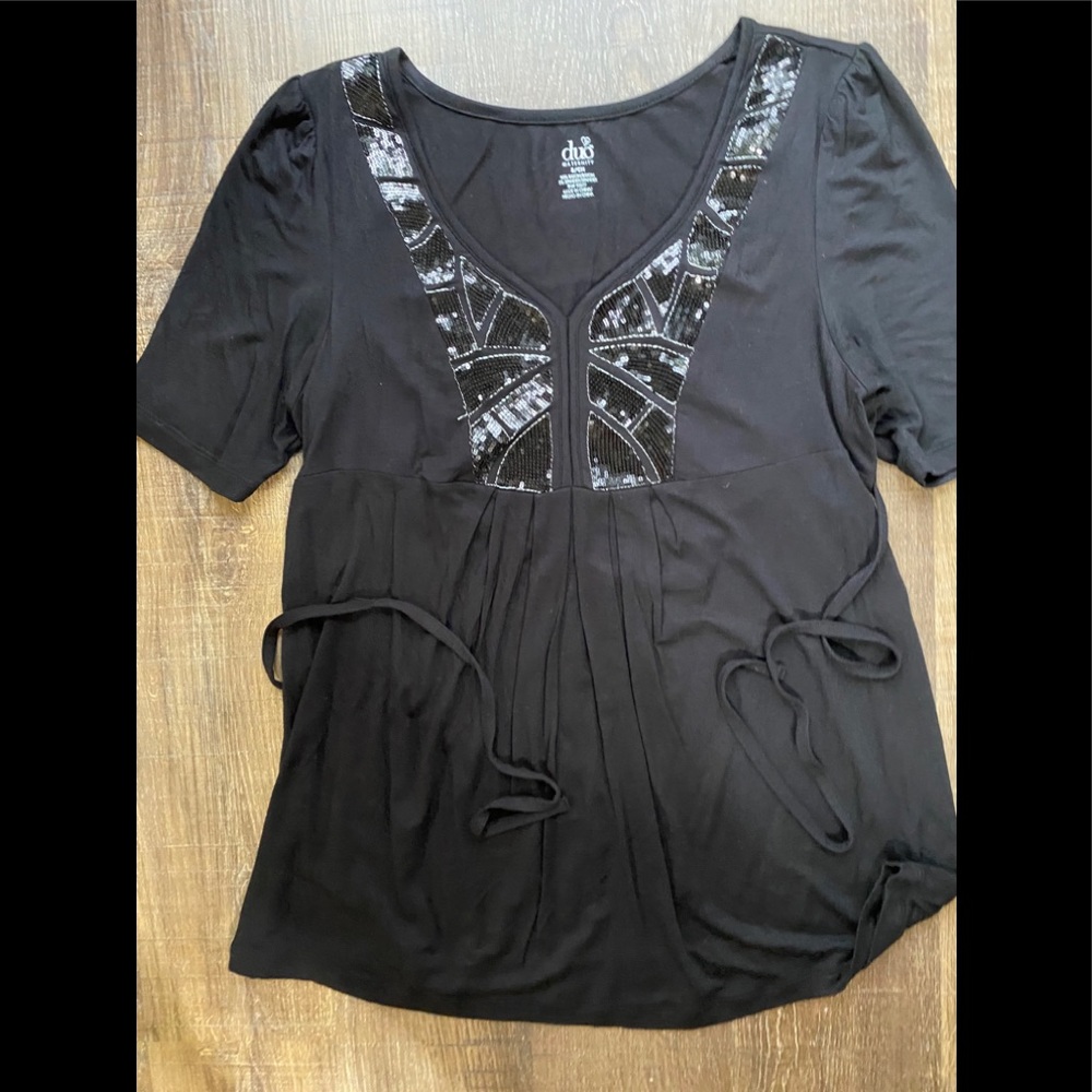 Black maternity top with sequin.